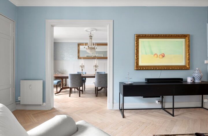 A living room filled with furniture and a painting on the wall