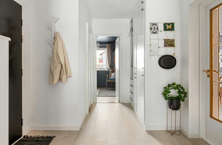 A long hallway with white walls and wood floors